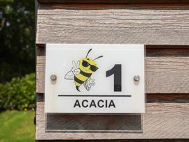 A sign featuring a bee illustration and the number 1 at Honeypot Hideaways - Acacia