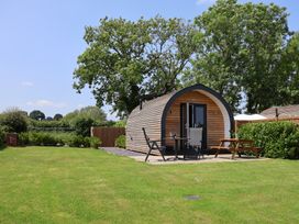 A cabin with outdoor seating at Honeypot Hideaways - Acacia