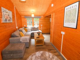 A living room with a sofa and coffee table at Stumps Cross Lodge in Upper Coscombe near Winchcombe