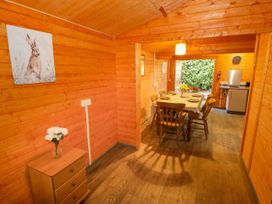 A dining room with a table and chairs at Stumps Cross Lodge in Upper Coscombe near Winchcombe