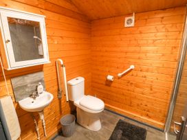 A bathroom with a toilet, sink, and shower at Stumps Cross Lodge Upper Coscombe near Winchcombe