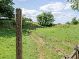 A path marked by a signpost at Stumps Cross Lodge in Upper Coscombe near Winchcombe