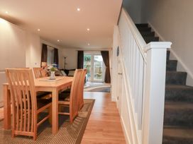 A dining room with a table and chairs at Fistral Palms 2 