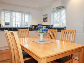 A dining room with a table and chairs at Fistral Palms 2 