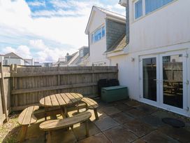 A garden area with a table and chairs at Fistral Palms 2 in Newquay