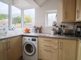 A kitchen with a washing machine and a fruit bowl at 20 Lym Close