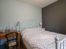 A bedroom with a bed and desk at 20 Lym Close
