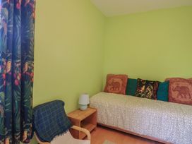 A bedroom with a bed and a chair at 20 Lym Close