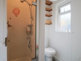A bathroom with a shower and toilet at 20 Lym Close