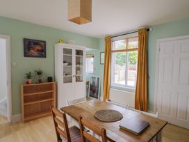 A dining room with a table and chairs at 20 Lym Close in Lyme Regis