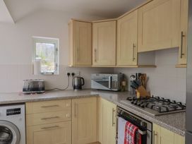 A kitchen with appliances and cabinets at 20 Lym Close in Lyme Regis