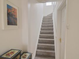 A staircase and storage boxes in a hallway at 20 Lym Close in Lyme Regis