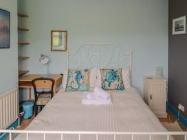 A bedroom featuring a bed with pillows and towels at 20 Lym Close in Lyme Regis