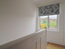 A landing with a window and curtain at 20 Lym Close in Lyme Regis