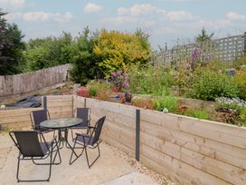 A garden with a table and chairs at 20 Lym Close in Lyme Regis