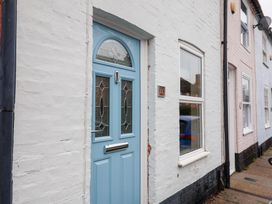A front entrance with a blue door and a nearby window at Deben Road in Woodbridge