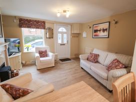 A living room with a sofa and armchair at Deben Road in Woodbridge
