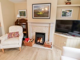 A living room with an armchair and a fireplace at Deben Road in Woodbridge