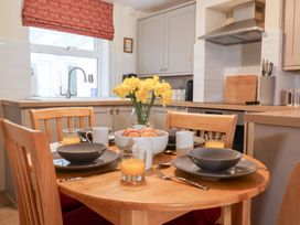 A kitchen with a dining table set for breakfast at Deben Road in Woodbridge