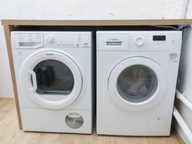 A dryer and washing machine in a laundry room at Deben Road in Woodbridge