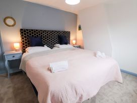 A bedroom with a bed and bedside tables at Deben Road Woodbridge