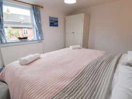 A bedroom with a bed and wardrobe at Deben Road in Woodbridge