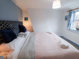 A bedroom with a large bed and pillows at Deben Road in Woodbridge