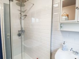 A shower with glass door and sink at Deben Road in Woodbridge