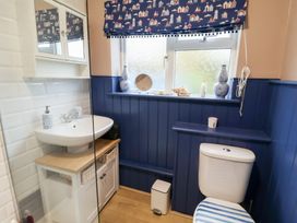 A bathroom with a sink, toilet, and window at Deben Road in Woodbridge
