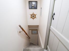 A staircase with a handrail and nautical decor at Deben Road in Woodbridge