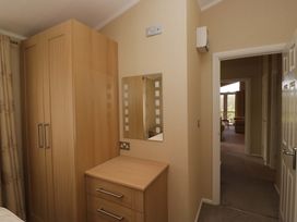 A bedroom with a wardrobe and chest of drawers at Wansfell 2 in Limefitt Park near Troutbeck