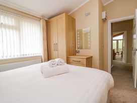 A bedroom with a double bed and wardrobe at Wansfell 2 Limefitt Park near Troutbeck