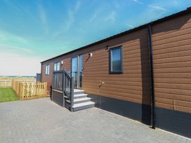 An outdoor area with a steps and a door at Sand & Serenity in Bacton