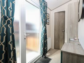 A hallway with curtains and a storage unit at Sand & Serenity in Bacton