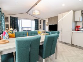 A dining room with a table and chairs at Sand & Serenity in Bacton