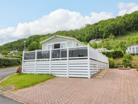 A house with a white fence and a pathway at Ty Seren in New Quay