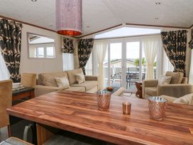 A living room with a sofa and table at Ty Seren in New Quay