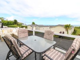 An outdoor seating area with a table and chairs at Ty Seren in New Quay