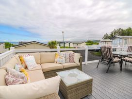 An outdoor seating area with a sofa and table at Ty Seren in New Quay