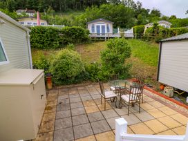 An outdoor patio with a table and chairs at Ty Seren in New Quay