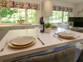 A kitchen with a dining table set for two at Stoney Rock Lodge