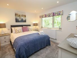 A bedroom with a bed and bedside tables at Stoney Rock Lodge