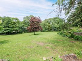 A garden with a tree and grassy area at Stoney Rock Lodge