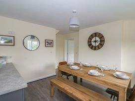A dining room with a wooden table and chairs at Glandwr House in Crossgates near Llandrindod Wells