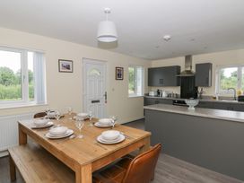 A kitchen with a dining table set for a meal at Glandwr House in Crossgates near Llandrindod Wells