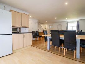 A dining room with a table and chairs at Sea Thrift White Cross near Indian Queens