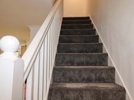 A staircase with carpet steps and a handrail at Sea Thrift near Indian Queens
