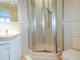 A bathroom with a shower, sink, and toilet at Sea Thrift in White Cross near Indian Queens