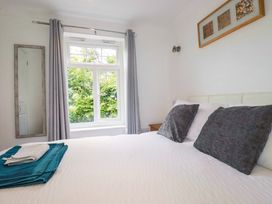 A bedroom with a bed and window at Sea Thrift White Cross near Indian Queens