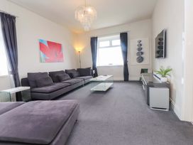 A living room with a sofa and coffee table at Sea Views No 8 Plas Darien, Trearddur Bay
